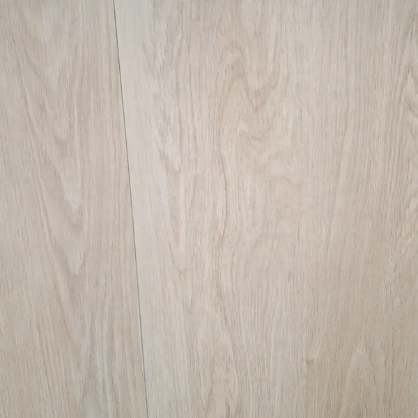 Detalle del piso SPC (Stone Plastic Composite) color beige claro, formato L, con superficie vinílica decorativa imitación madera, fácil instalación tipo click y resistencia a rayones y desgaste.
